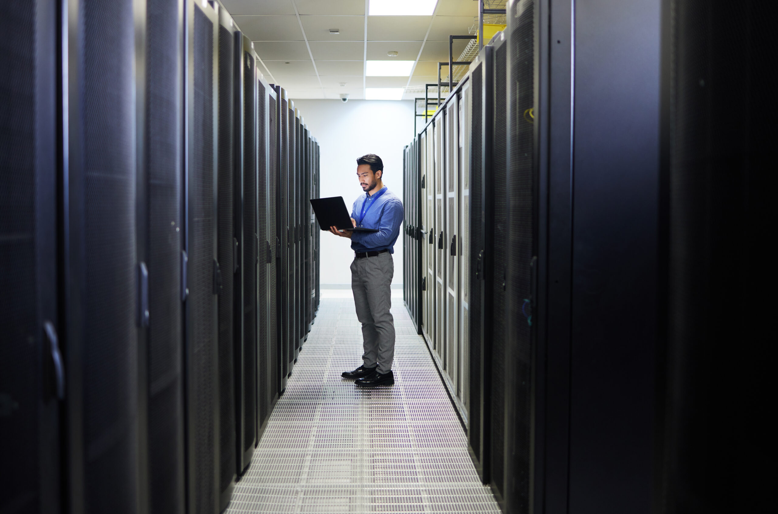 Server room, laptop or man typing for cybersecurity glitch, machine or to search online for servers.